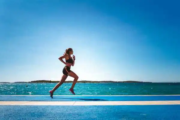Woman running showing strong leg muscle Telford